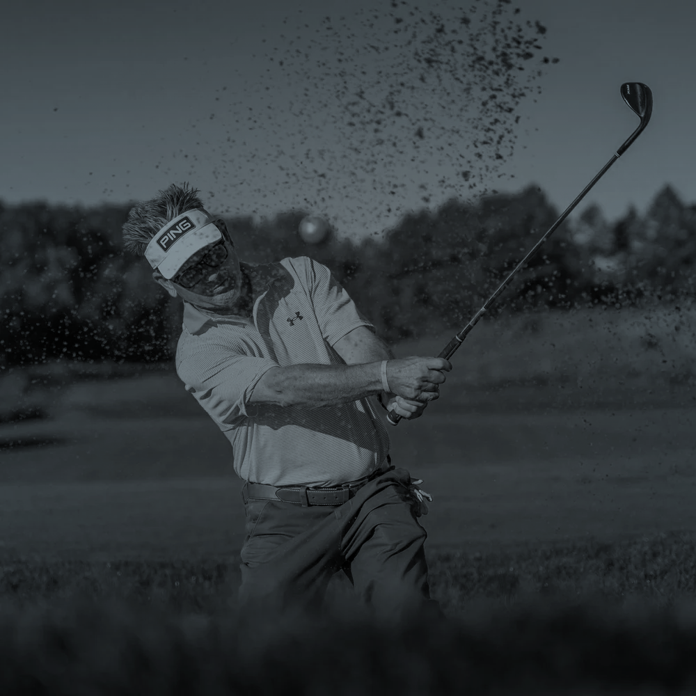 Golfer golfing his way out of the sand